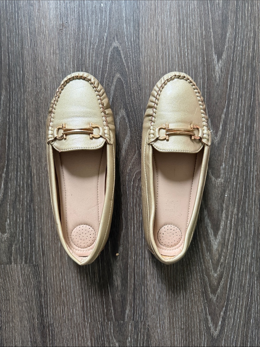 Women gold faux leather moccasin loafers featuring a rounded toe, light